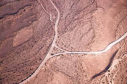 aerial view aerial photo of road on desert during daytime grand canyon village